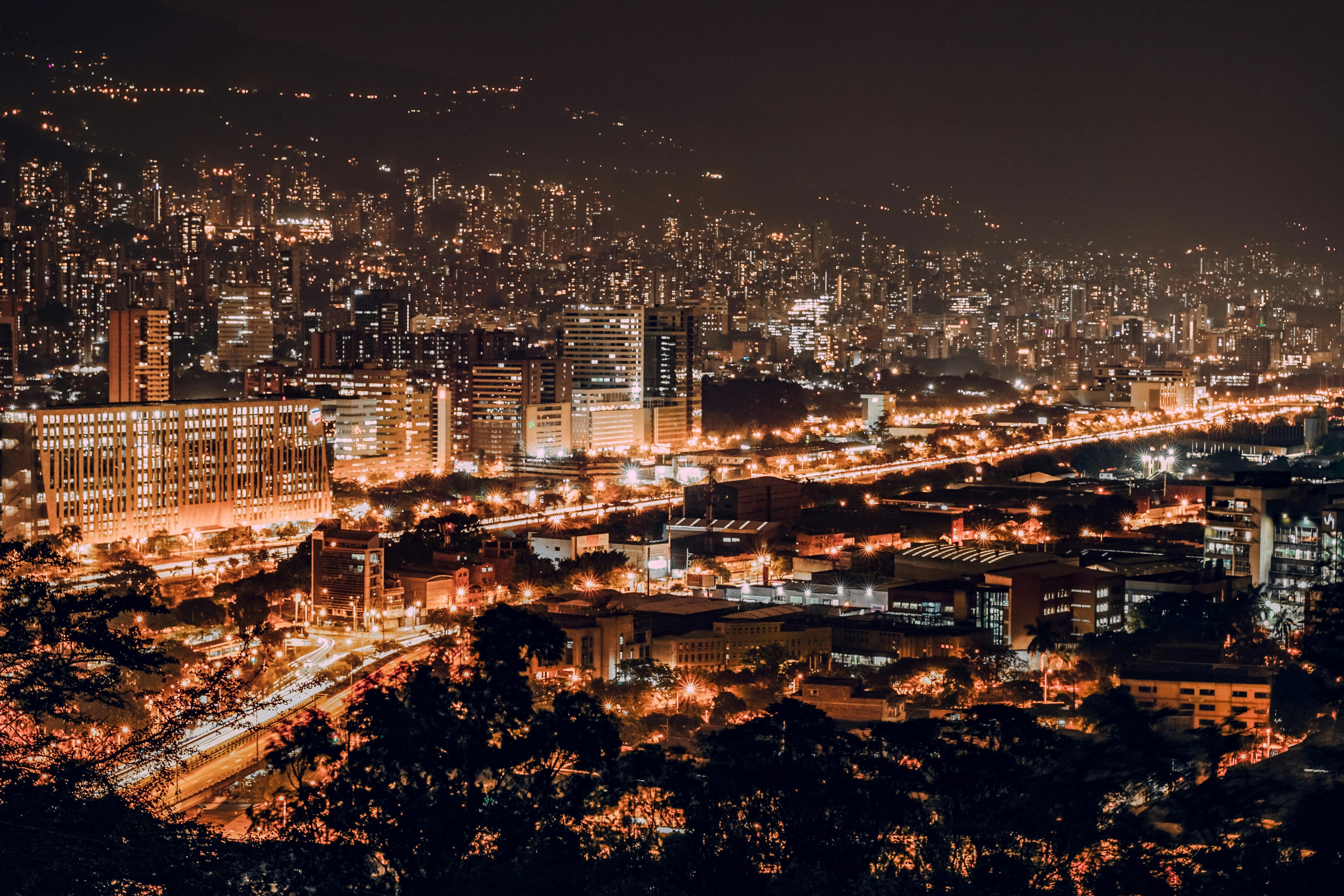 Night city skyline with bright artificial lights, illustrating urban light pollution and its impact on sleep and circadian rhythm